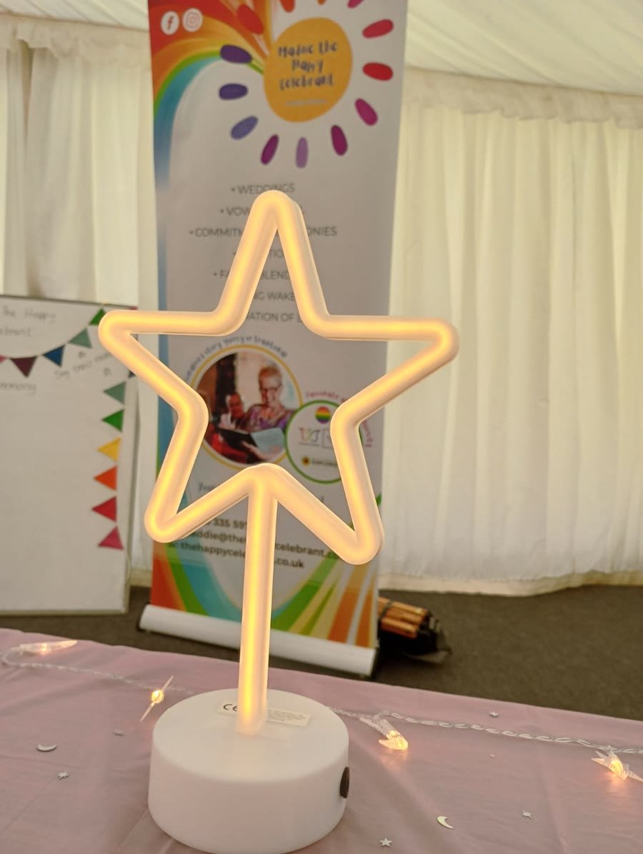 A glowing star lamp, with Maddie's banner in the background
