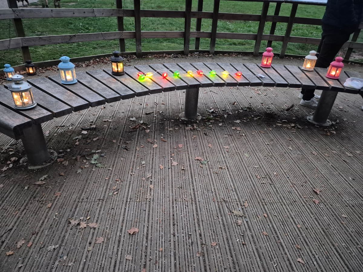 Lanterns and ribbons set out along the curved bench of the wooden platform